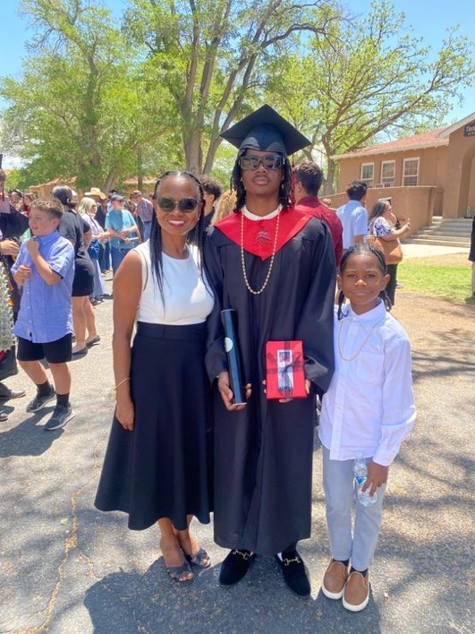 An Anguillian graduate with family at the Menaul High School graduation