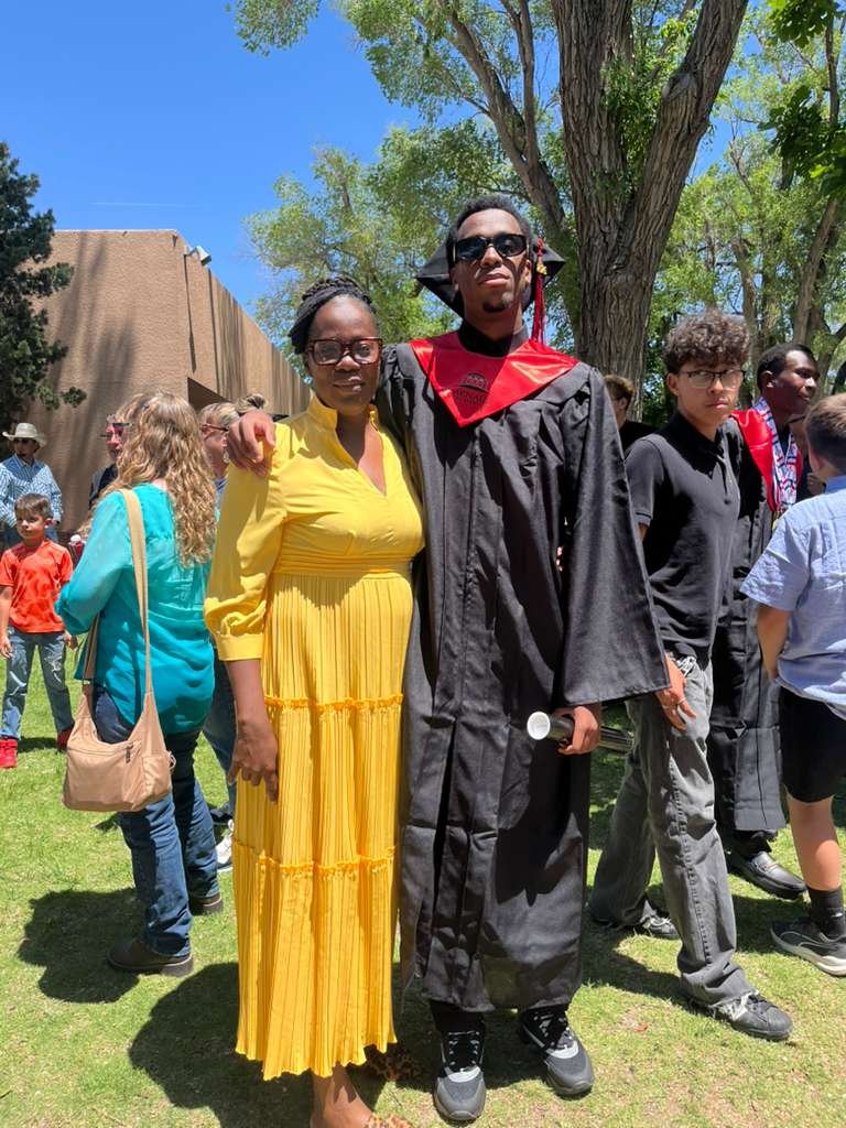 An Anguillian graduate celebrates with family at Menaul High School