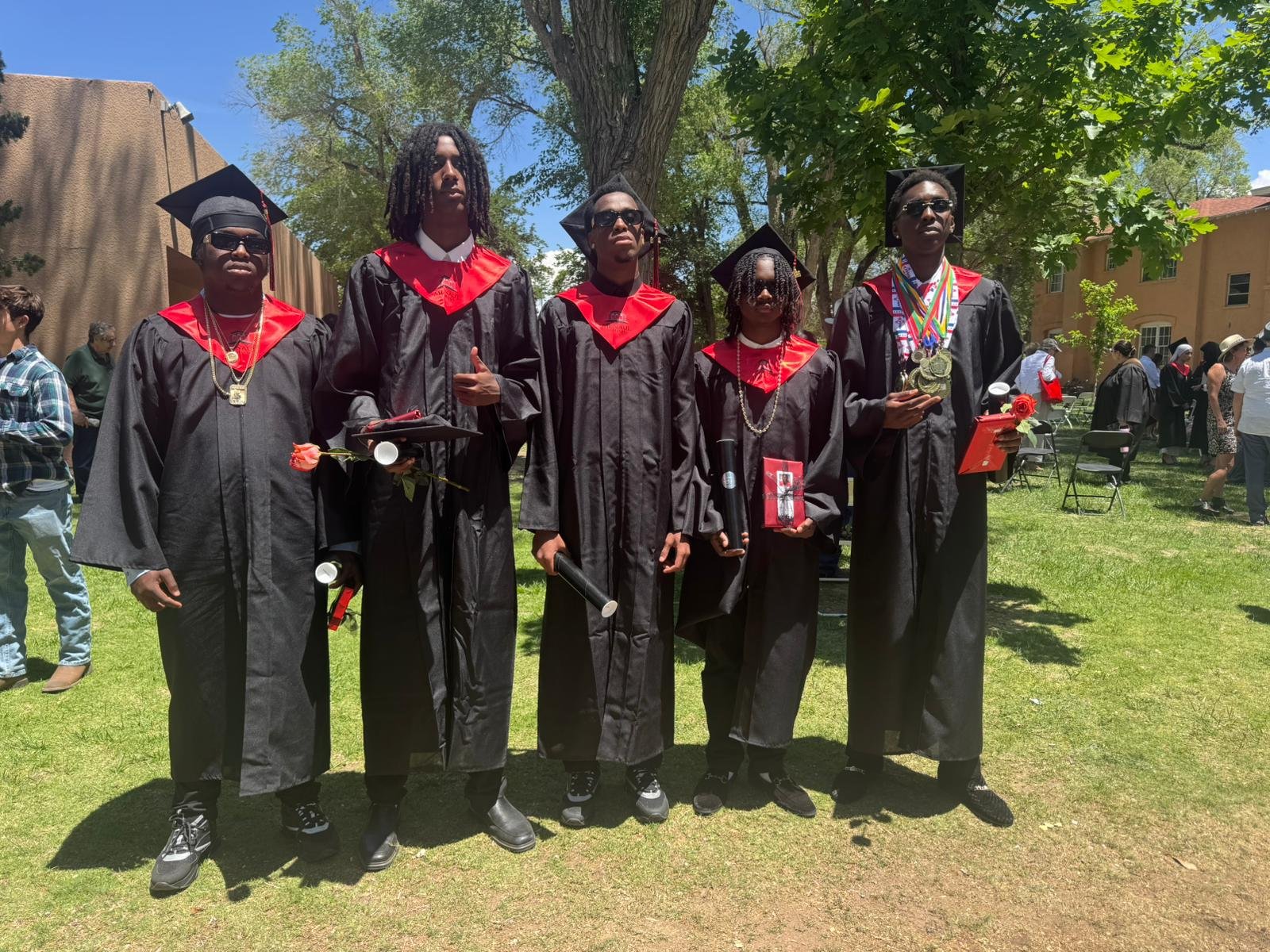 Five Anguillian student-athletes in caps and gowns at their Menaul High School graduation in New Mexico