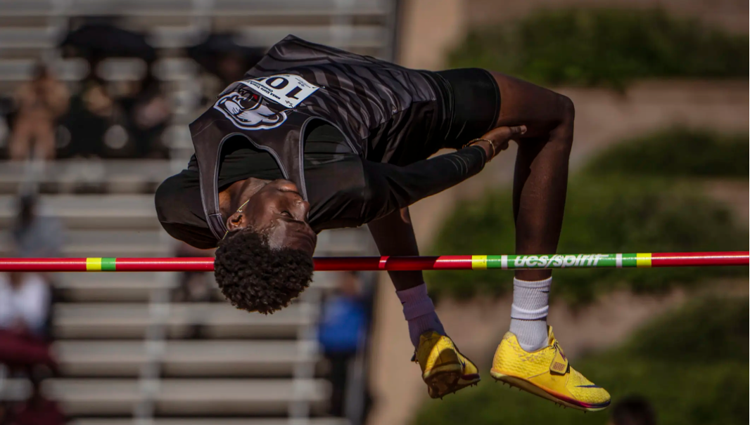 J'quan Samuels of Menaul High School clears the bar in the high jump at the New Mexico Class A-3A state track and field championships